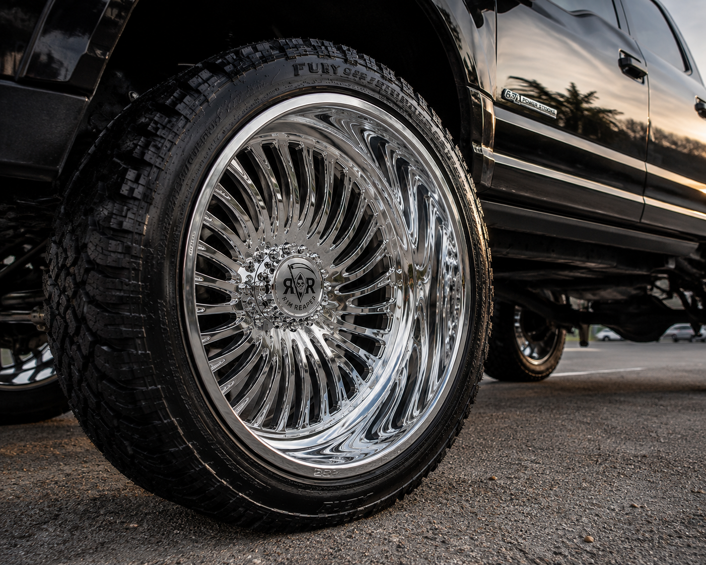 Polished Rim Reaper forged wheel mounted on a lifted black Ford Super Duty